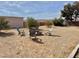 Wide backyard featuring a fire pit with four chairs in a relaxing setting at 325 Ron Ave, Logandale, NV 89021