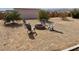 Spacious backyard with a fire pit and four chairs for outdoor gatherings at 325 Ron Ave, Logandale, NV 89021