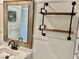 Bathroom vanity featuring a wood-framed mirror and a metal shelving unit at 325 Ron Ave, Logandale, NV 89021