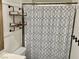 Bathroom featuring a shower with an ornate shower curtain and a metal shelf at 325 Ron Ave, Logandale, NV 89021