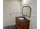 Bathroom features dark vanity with sink and large gold-framed mirror, and a white door at 325 Ron Ave, Logandale, NV 89021