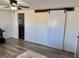 Bedroom with wood-style flooring, ceiling fan, barn door access to a bathroom at 325 Ron Ave, Logandale, NV 89021