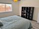 Bedroom with a queen bed, wood-style flooring, and a window looking to the outside at 325 Ron Ave, Logandale, NV 89021