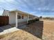 Exterior view of a home featuring a covered side patio and clean landscaping at 325 Ron Ave, Logandale, NV 89021