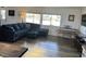 Well-lit living room with a sectional sofa, piano, and large windows at 325 Ron Ave, Logandale, NV 89021