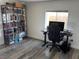 Home office featuring a large bookcase and an adjustable desk with office chair at 325 Ron Ave, Logandale, NV 89021