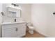 Modern bathroom with a white single sink vanity, black faucet, and a toilet in a clean, bright space at 3400 Cabana Dr # 1084, Las Vegas, NV 89122