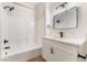 Bright bathroom featuring tub-shower combo with black hardware and a white single sink vanity at 3400 Cabana Dr # 1084, Las Vegas, NV 89122