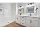 Modern bathroom featuring double sink vanities with black faucets and a tub-shower combination at 3400 Cabana Dr # 1084, Las Vegas, NV 89122