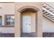 Arched doorway with secure white door to unit 1084, offering privacy and protection at 3400 Cabana Dr # 1084, Las Vegas, NV 89122