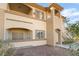 Inviting condominium exterior featuring stucco walls, arched entryways, and multiple levels of living at 3400 Cabana Dr # 1084, Las Vegas, NV 89122