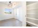 Bright living room with light wood floors, a modern light fixture, and a window with blinds at 3400 Cabana Dr # 1084, Las Vegas, NV 89122