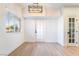 Bright living room with light wood floors, a modern light fixture, and a large window with blinds at 3400 Cabana Dr # 1084, Las Vegas, NV 89122