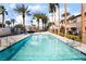 Sparkling community pool surrounded by lush landscaping and palm trees, creating a relaxing oasis at 3400 Cabana Dr # 1084, Las Vegas, NV 89122