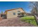 Backyard featuring a patio, artificial grass, and desert landscaping at 3531 Barrel Bronco Ct, North Las Vegas, NV 89032