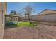 Backyard featuring a patio, artificial grass, and desert landscaping at 3531 Barrel Bronco Ct, North Las Vegas, NV 89032