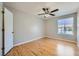 Bedroom featuring a ceiling fan, wood flooring, and a bright window at 3531 Barrel Bronco Ct, North Las Vegas, NV 89032