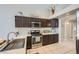 Modern kitchen with stainless steel appliances and dark wood cabinets at 3531 Barrel Bronco Ct, North Las Vegas, NV 89032