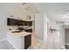 Stylish kitchen featuring dark cabinetry and bar seating at 3531 Barrel Bronco Ct, North Las Vegas, NV 89032