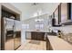 Well-equipped kitchen with stainless steel appliances, light countertops, and white tile flooring at 3531 Barrel Bronco Ct, North Las Vegas, NV 89032