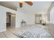 Open-concept living room with tile flooring, ceiling fan, and neutral color palette at 3531 Barrel Bronco Ct, North Las Vegas, NV 89032