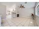 Bright living room featuring a fireplace, tile flooring, and a ceiling fan at 3531 Barrel Bronco Ct, North Las Vegas, NV 89032