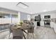 Staged kitchen and dining area with a granite countertops and modern black appliances at 3800 San Joaquin Ave, Las Vegas, NV 89102