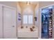 A spa-like bathroom with a soaking tub, plantation shutters, and a view of the walk in closet at 3882 Genoa Dr, Las Vegas, NV 89141