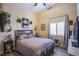 Cozy bedroom featuring a patterned quilt, plants, and bright window, creating a serene retreat at 3882 Genoa Dr, Las Vegas, NV 89141