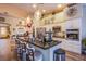 Bright, modern kitchen featuring a center island with bar seating, granite counters, and stainless steel appliances at 3882 Genoa Dr, Las Vegas, NV 89141