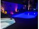 Backyard swimming pool and spa with colorful night illumination at 3882 Genoa Dr, Las Vegas, NV 89141