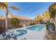 Inviting backyard pool and spa with ample seating and mature palm trees at 3882 Genoa Dr, Las Vegas, NV 89141