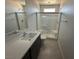 Modern bathroom with a glass enclosed shower, and vanity with dark wood cabinets at 4238 Lemay St # 2, Las Vegas, NV 89115