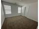 Clean bedroom with neutral carpet, two windows, and white walls at 4238 Lemay St # 2, Las Vegas, NV 89115