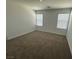 Bright bedroom with neutral carpet and two windows at 4238 Lemay St # 2, Las Vegas, NV 89115