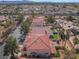 Expansive aerial view showcasing the neighborhood with lush landscaping and a terracotta tile roof at 4451 Tomer Ln, Las Vegas, NV 89121