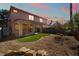 Backyard featuring an outdoor seating area, complemented by lush green artificial turf and desert landscaping at 4451 Tomer Ln, Las Vegas, NV 89121