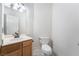 Powder room with tiled floors, wood vanity and a sink, and a toilet at 4451 Tomer Ln, Las Vegas, NV 89121