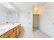 Bright bathroom features a double sink vanity, a shower-tub combination, and a shelving niche at 4451 Tomer Ln, Las Vegas, NV 89121