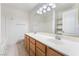 Bright bathroom featuring a double sink vanity, large mirror, and ample lighting at 4451 Tomer Ln, Las Vegas, NV 89121