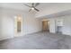 Spacious carpeted bedroom with ceiling fan and a glimpse of a walk-in closet and the ensuite bathroom at 4451 Tomer Ln, Las Vegas, NV 89121