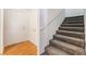 Entryway with carpeted stairs to upper level and wood-look laminate flooring leading to the front door at 4451 Tomer Ln, Las Vegas, NV 89121