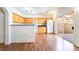 Bright kitchen with light wood cabinets, white appliances, granite countertops, and sliding glass doors to the patio at 4451 Tomer Ln, Las Vegas, NV 89121