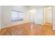 Bright living room featuring wood flooring, a large window, and a welcoming front door at 4451 Tomer Ln, Las Vegas, NV 89121