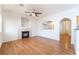 Living room featuring a cozy fireplace, wood flooring, and archways to other rooms at 4451 Tomer Ln, Las Vegas, NV 89121