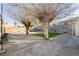 Spacious backyard with gravel, mature trees, artificial turf, and a concrete patio at 478 S Water St, Henderson, NV 89015