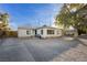 Charming single-story home featuring a well-maintained gravel front yard and a quaint patio area at 478 S Water St, Henderson, NV 89015