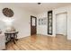 Cozy living room with hardwood floors, a decorative wall clock, and easy access to other rooms at 478 S Water St, Henderson, NV 89015