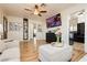 Spacious living room showcasing hardwood floors, modern furnishings, and a view into the kitchen at 478 S Water St, Henderson, NV 89015