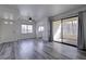 Bright living room with a ceiling fan, gray floors, and sliding doors to the balcony at 4877 S Torrey Pines Dr # 202, Las Vegas, NV 89103